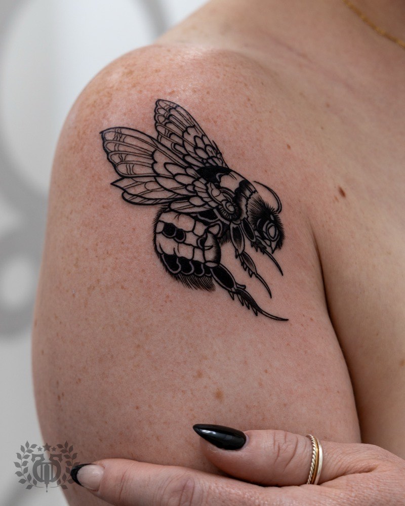 Ornamental sternum tattoo — jewelry-mimicking composition wrapping rib cage