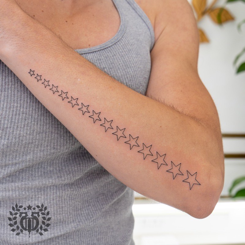 Fine line tattoo detail — delicate botanical work