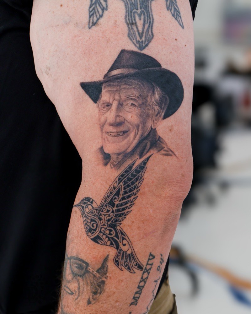 Realism animal portrait tattoo — dog rendered with detailed fur texture