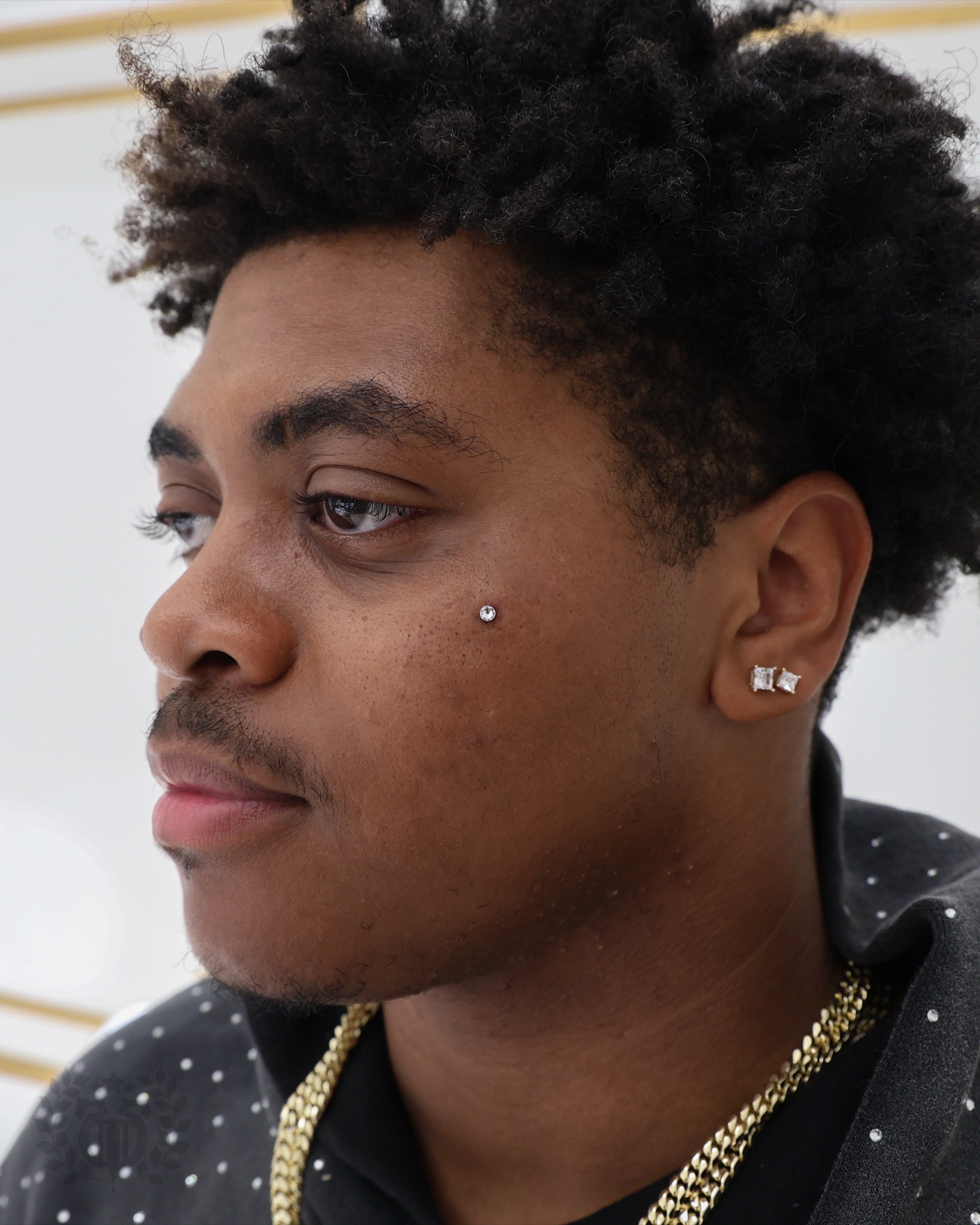 Client receiving a body piercing with premium jewelry in Santa Monica