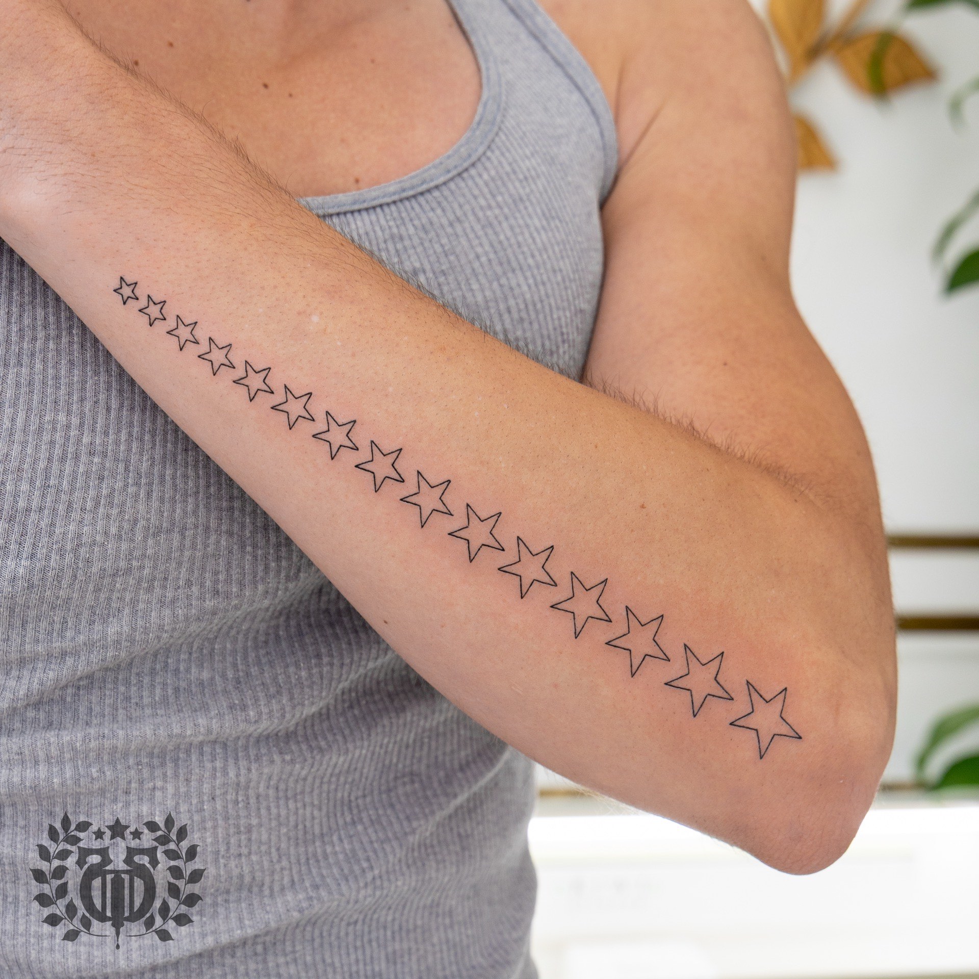 Graduated stars tattoo by fine line tattoo artist in Los Angeles