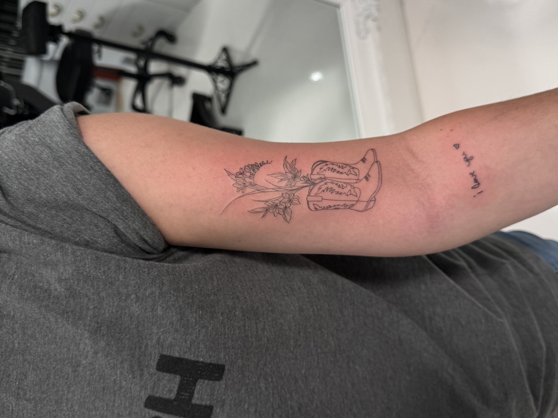 Sneaker with wildflowers tattoo by fine line tattoo artist in Los Angeles