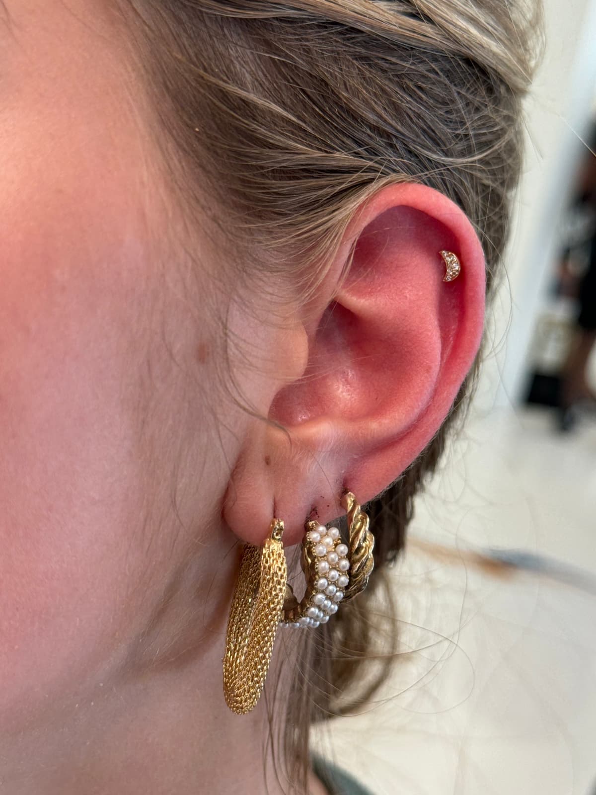 BVLA gold flat back curated piercing at Apollo Studio