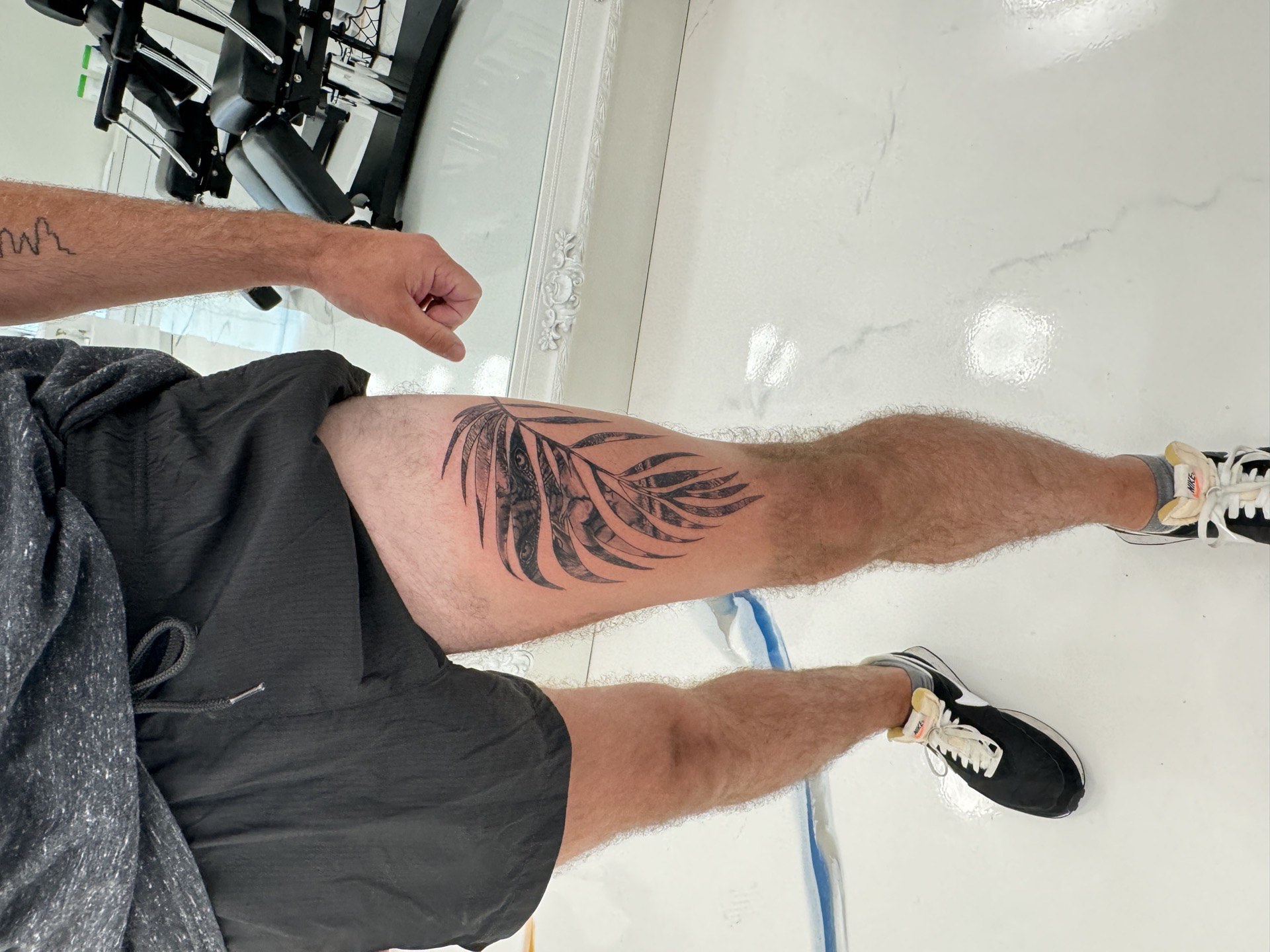 Black and grey realistic palm frond tropical leaf realism tattoo in Los Angeles