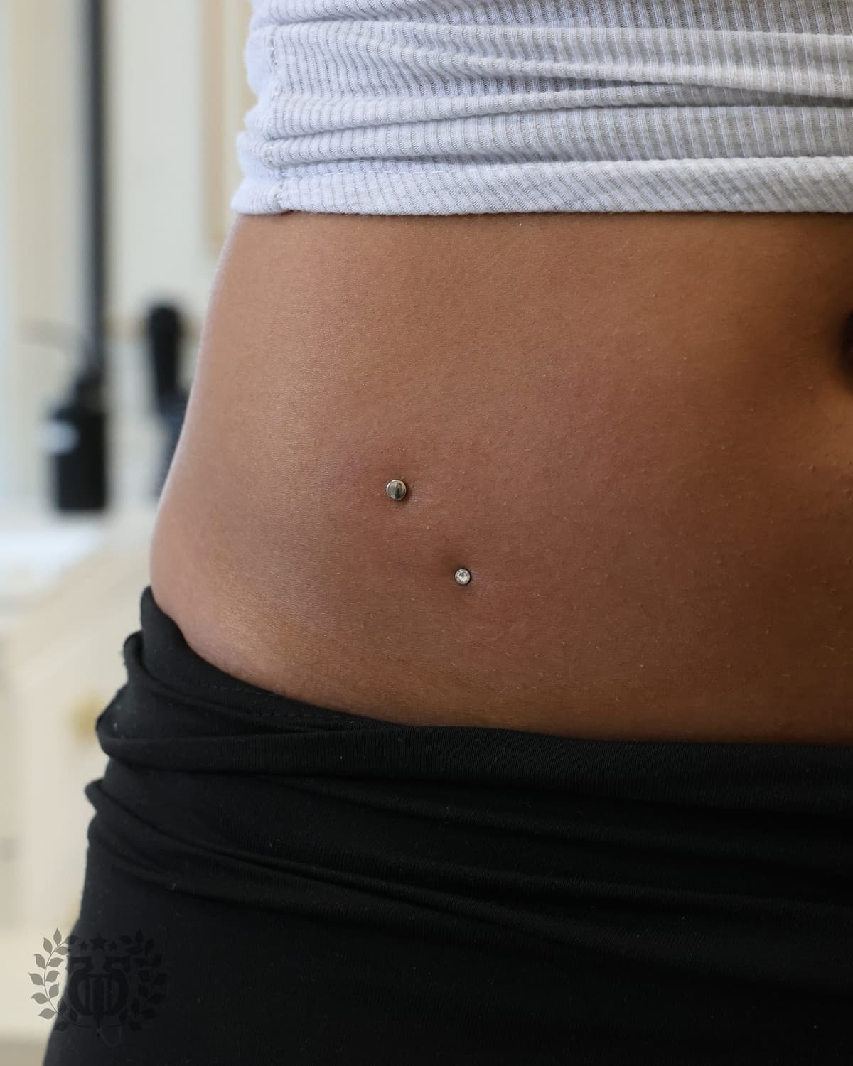 Double surface anchor dermal piercings with CZ tops extreme close-up at Apollo LA