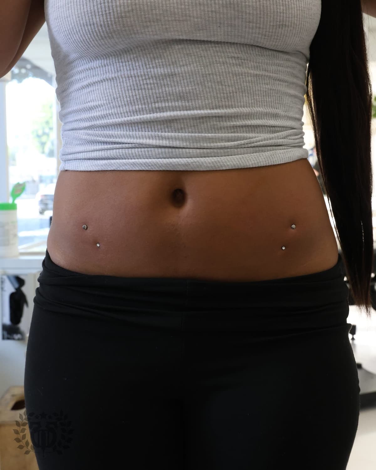 Cheekbone dermal anchor piercing with CZ top on male client at Apollo Tattoo and Piercing