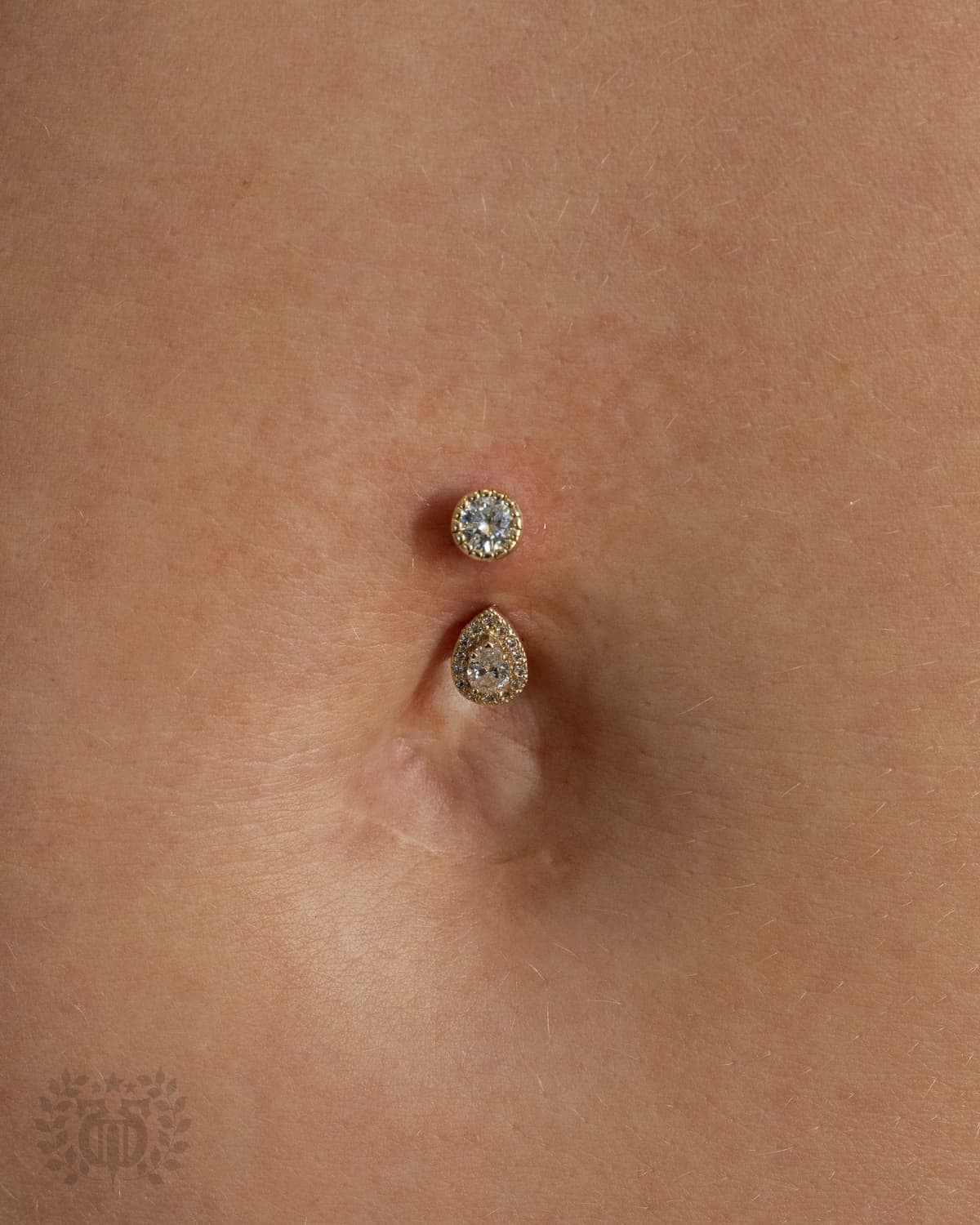 Belly button piercing with princess-cut diamond CZ curved barbell at Apollo Studio Los Angeles