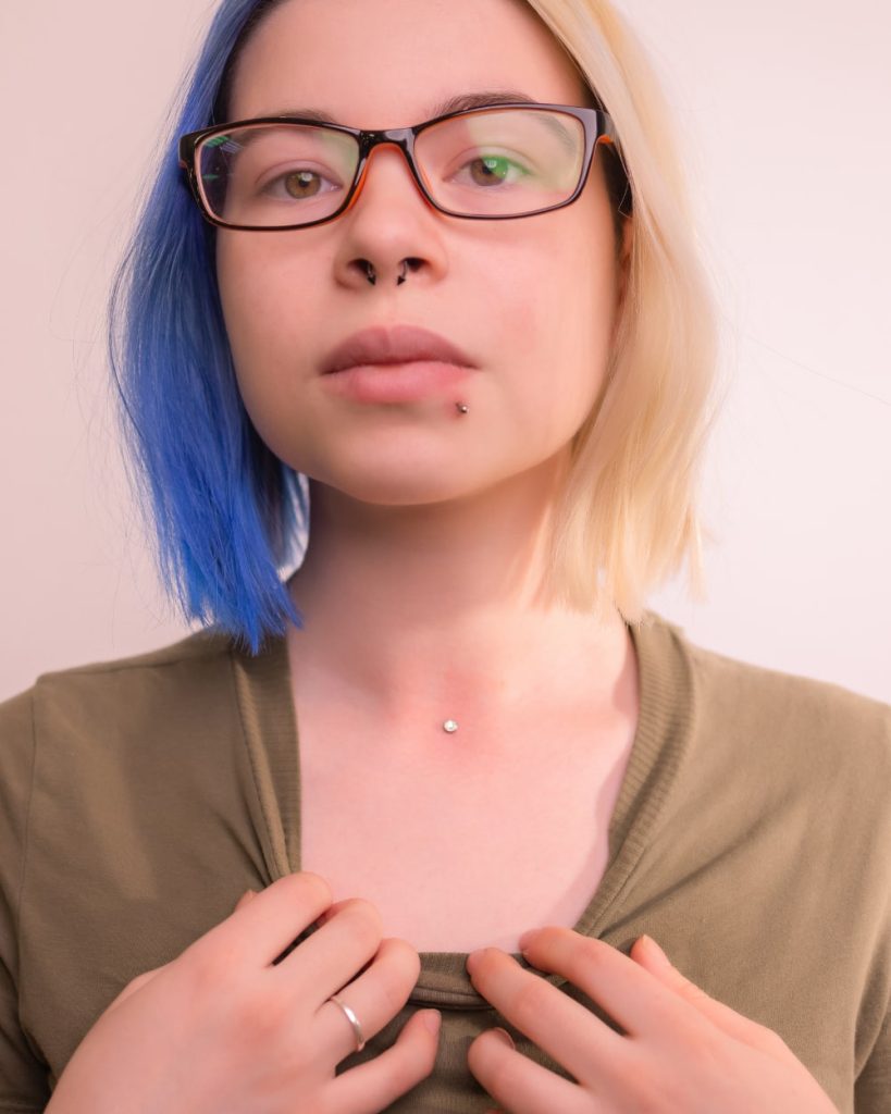woman showing dermal piercing